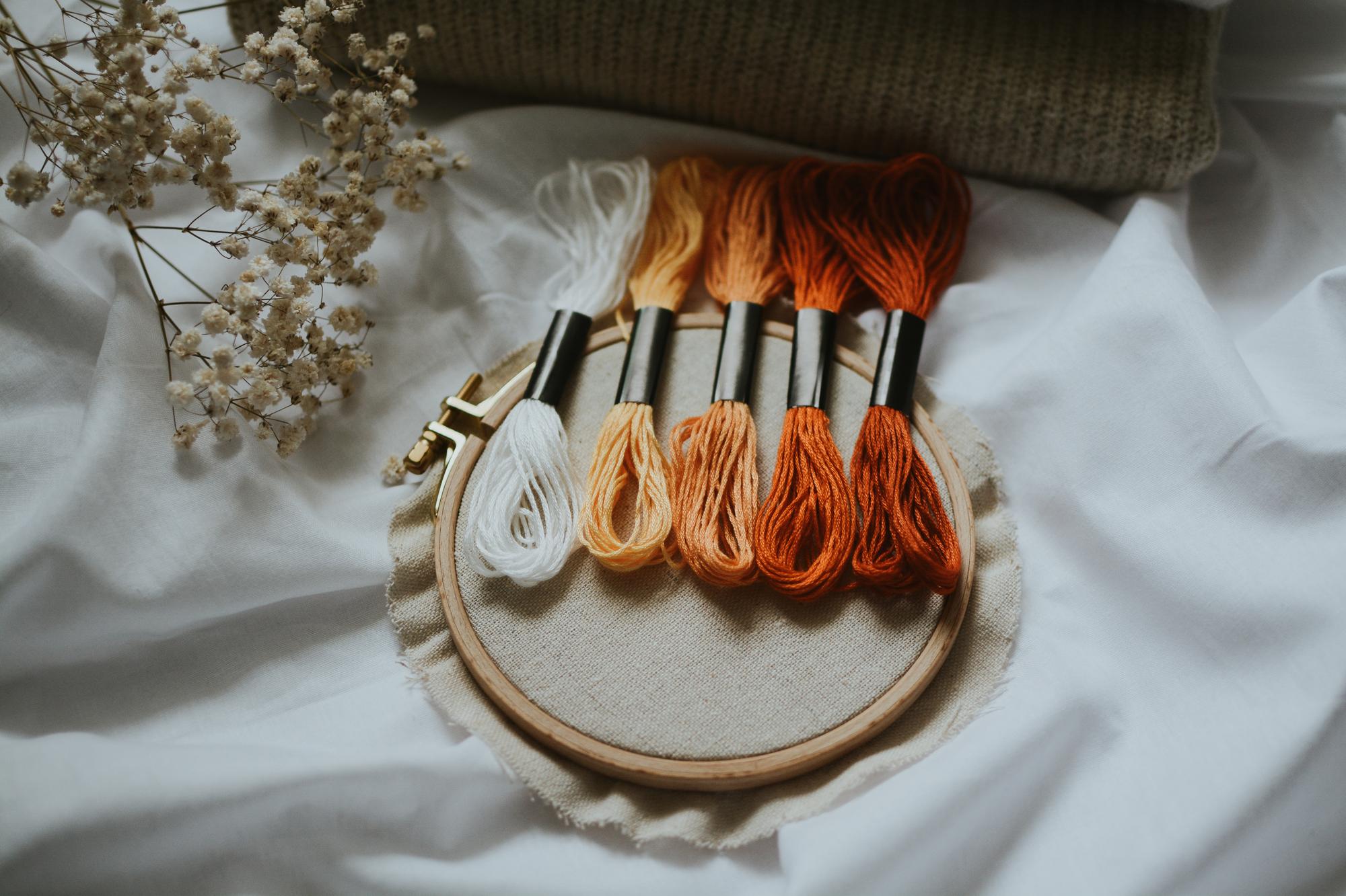 Assorted embroidery threads and sample cards